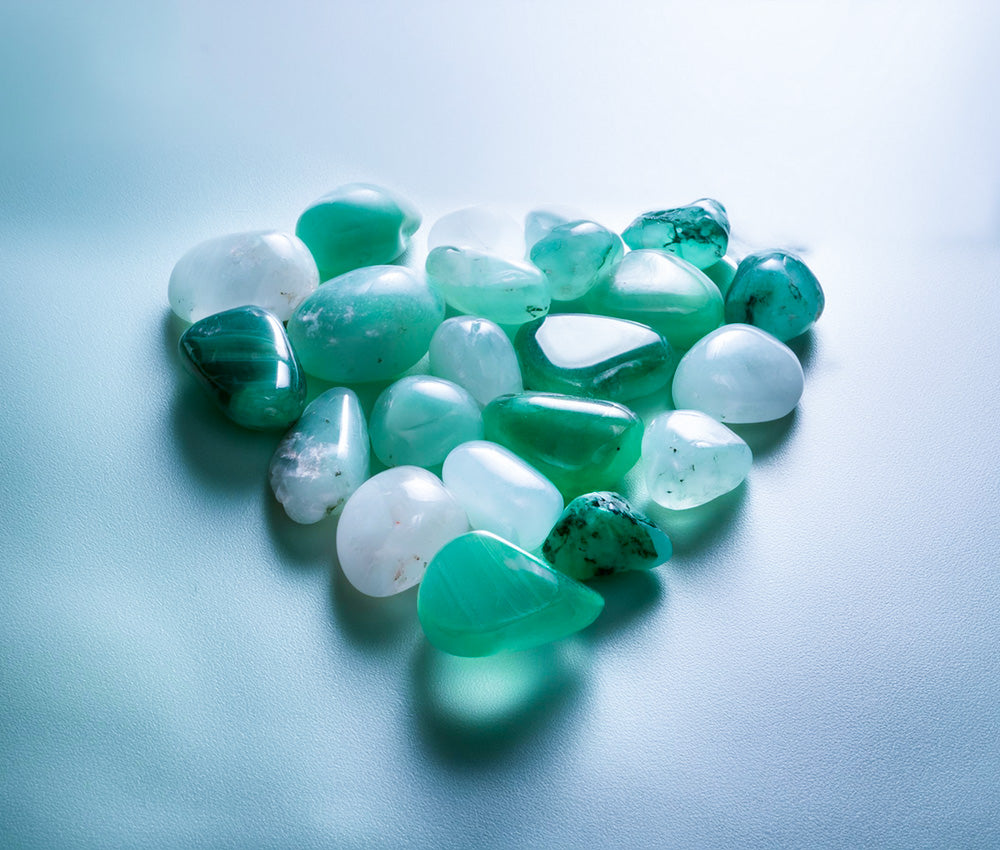 Aventurine stones placed on a smooth surface with soft lighting, highlighting their connection to the Heart Chakra and emotional healing.