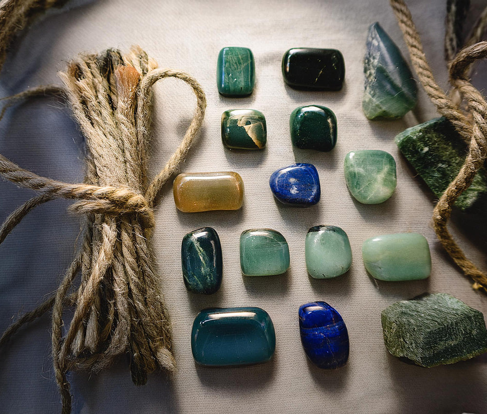 Tourmaline stones arranged by color, highlighting their connections to multiple chakras for balance, love, and communication.