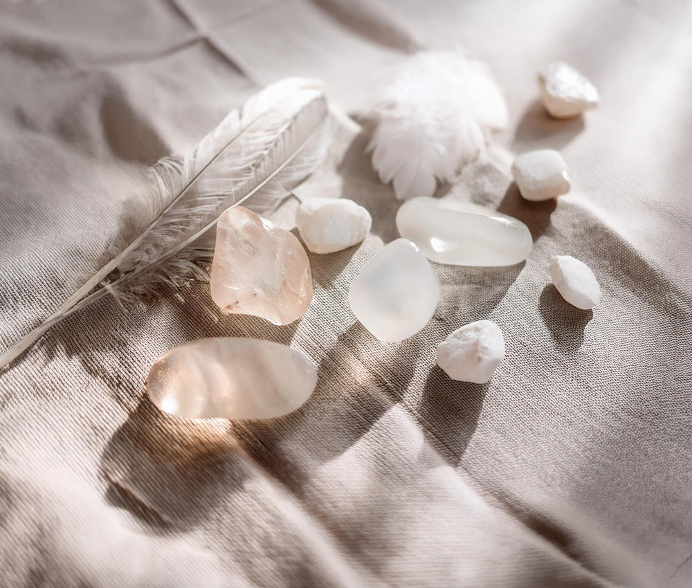 Clear quartz stones on a light surface, symbolizing spiritual communication, energy amplification, and historical significance.