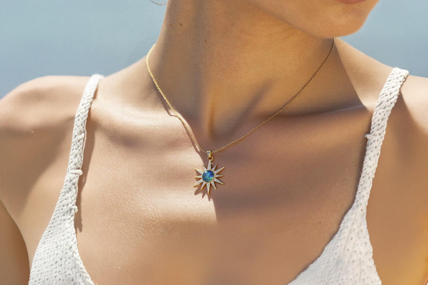 Woman wearing a crystal pendant necklace for heart chakra healing