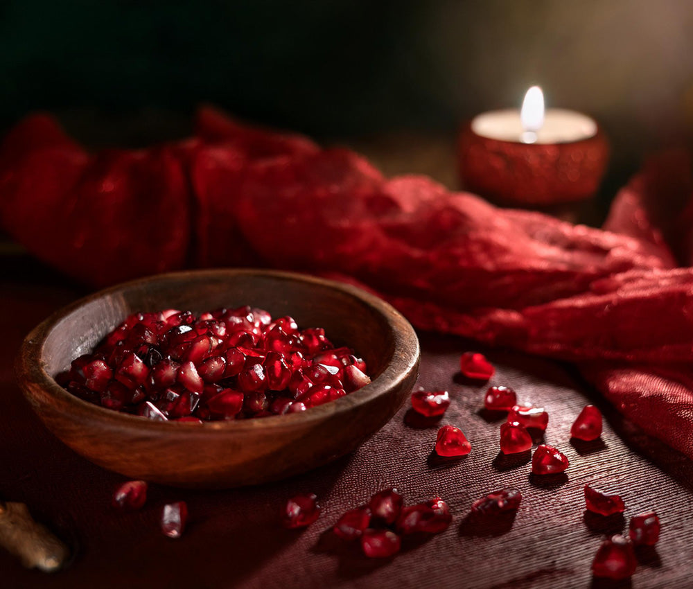 Deep red garnet stones on a textured surface, symbolizing passion, vitality, and emotional strength.