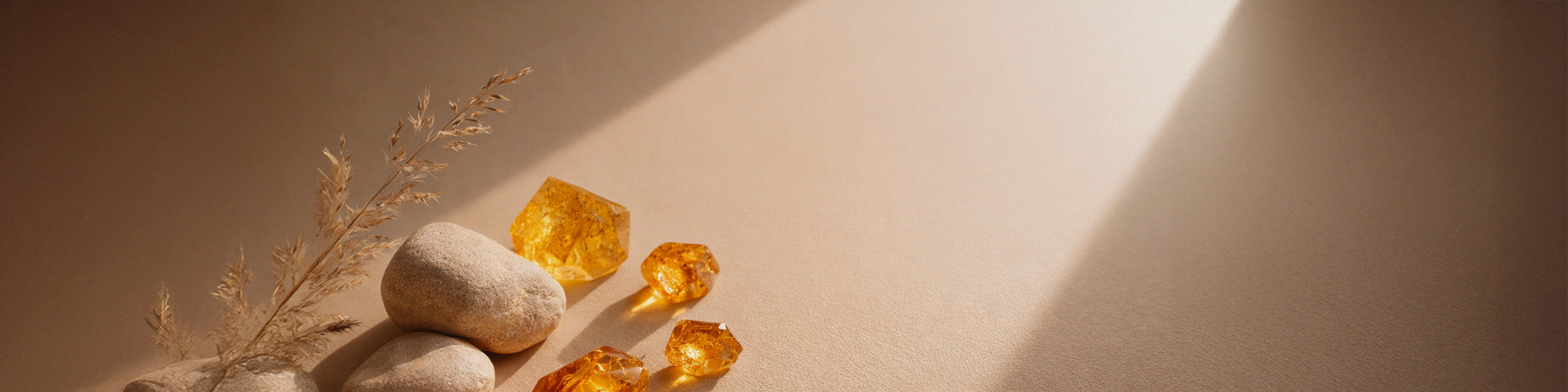 Healing crystal jewelry and gemstone decor on a warm neutral background