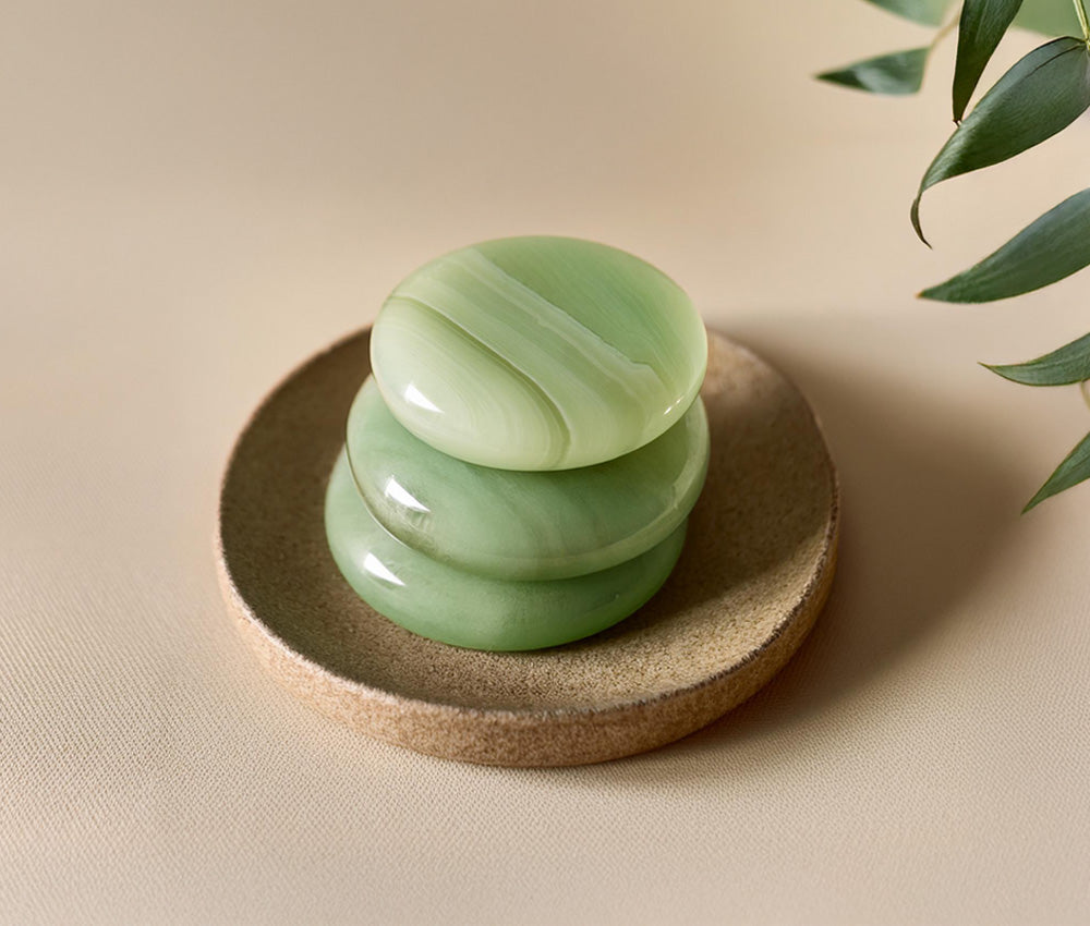 Smooth jade stones on a neutral background with subtle cultural accents, symbolizing protection, purity, and abundance.