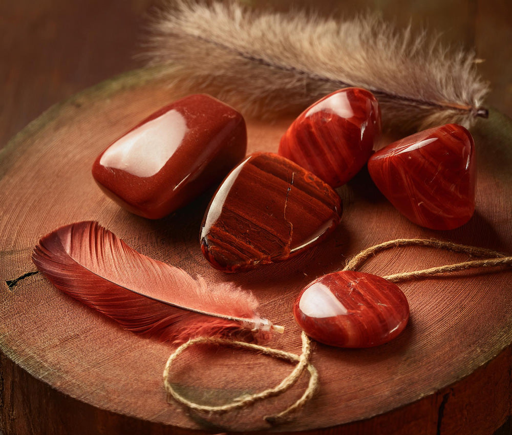 Jasper stones on a natural surface with earthy tones, symbolizing protection, strength, and connection to the earth.