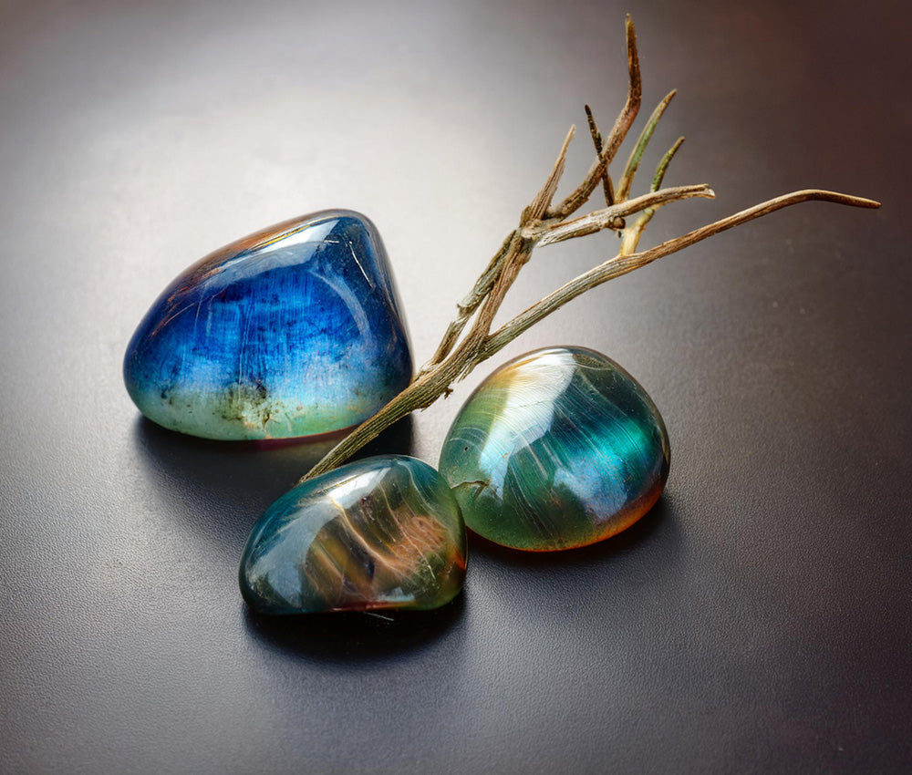 Labradorite stones on a dark surface, showcasing their iridescent colors and connection to ancient legends and spiritual protection.