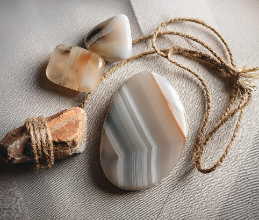 Onyx stones on a neutral background, highlighting their connection to the Root Chakra and promoting grounding and resilience.