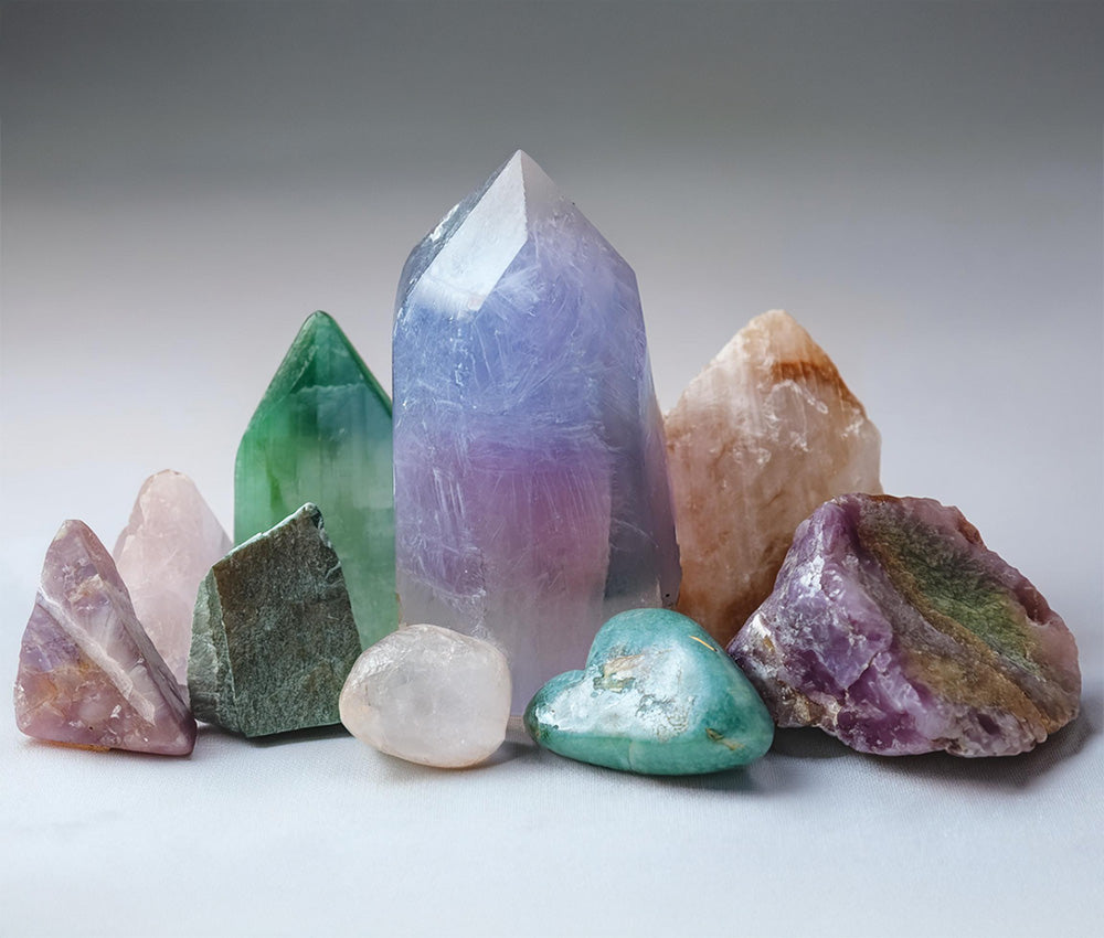 Fluorite stones placed on a neutral background, highlighting their connection to the Third Eye, Heart, and Crown Chakras.