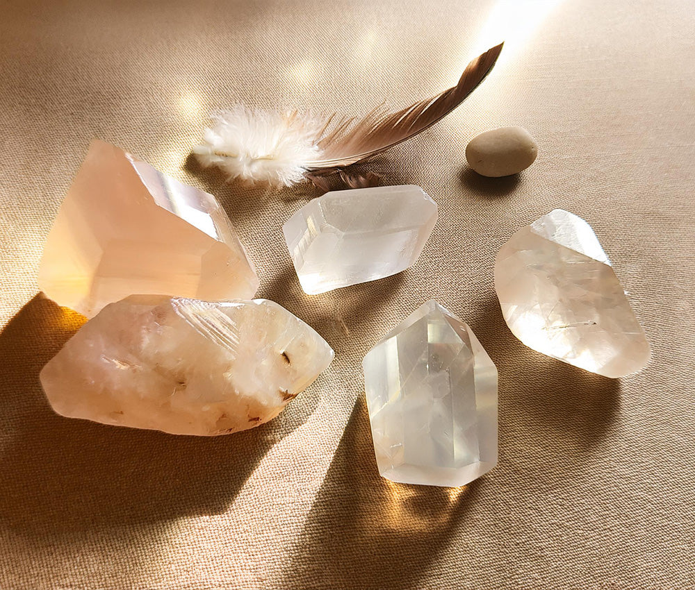 Quartz crystals on a neutral surface, symbolizing their historical use in healing, clarity, and spiritual ceremonies.