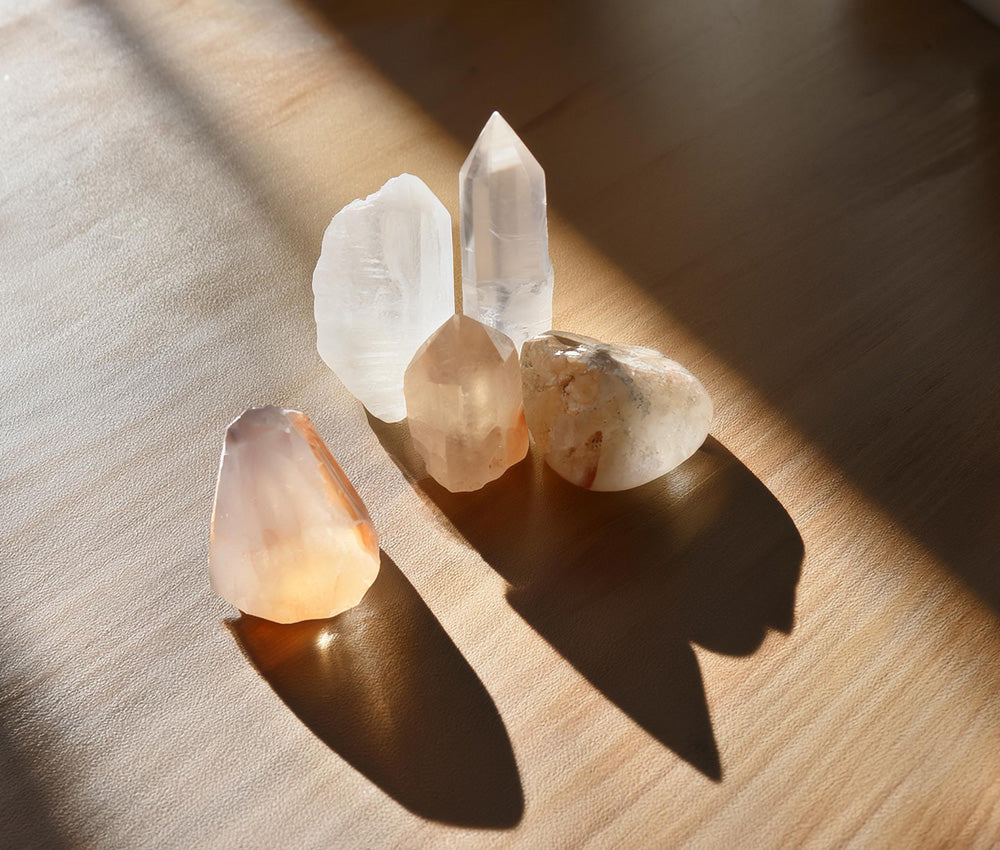 Clear quartz stones on a neutral background, highlighting their connection to the Crown Chakra and universal energy.