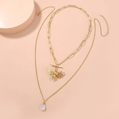 Elegant Gold Layered Necklace with Butterfly Pendant Gems Ritual