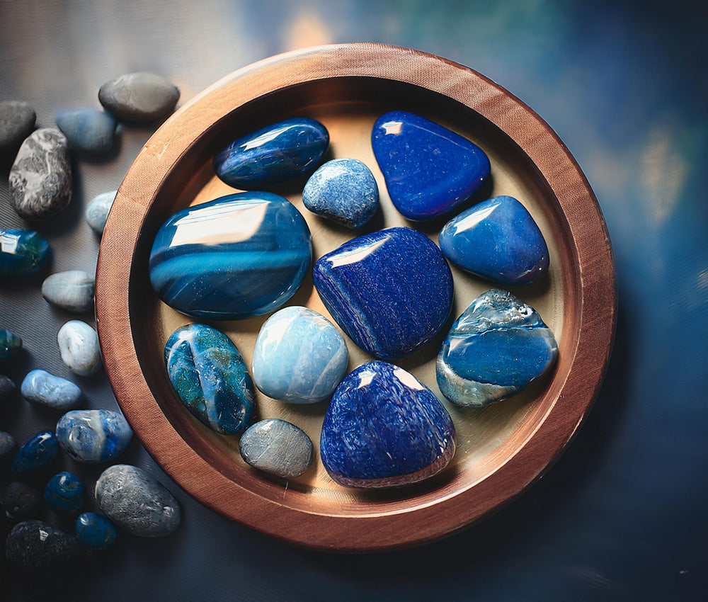 Lapis lazuli stones on a neutral surface, emphasizing their connection to the Third Eye and Throat Chakras for intuition and clear communication.