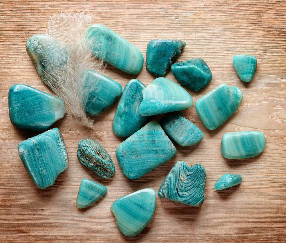 Turquoise stones on a textured surface, symbolizing protection, prosperity, and their historical significance across cultures.